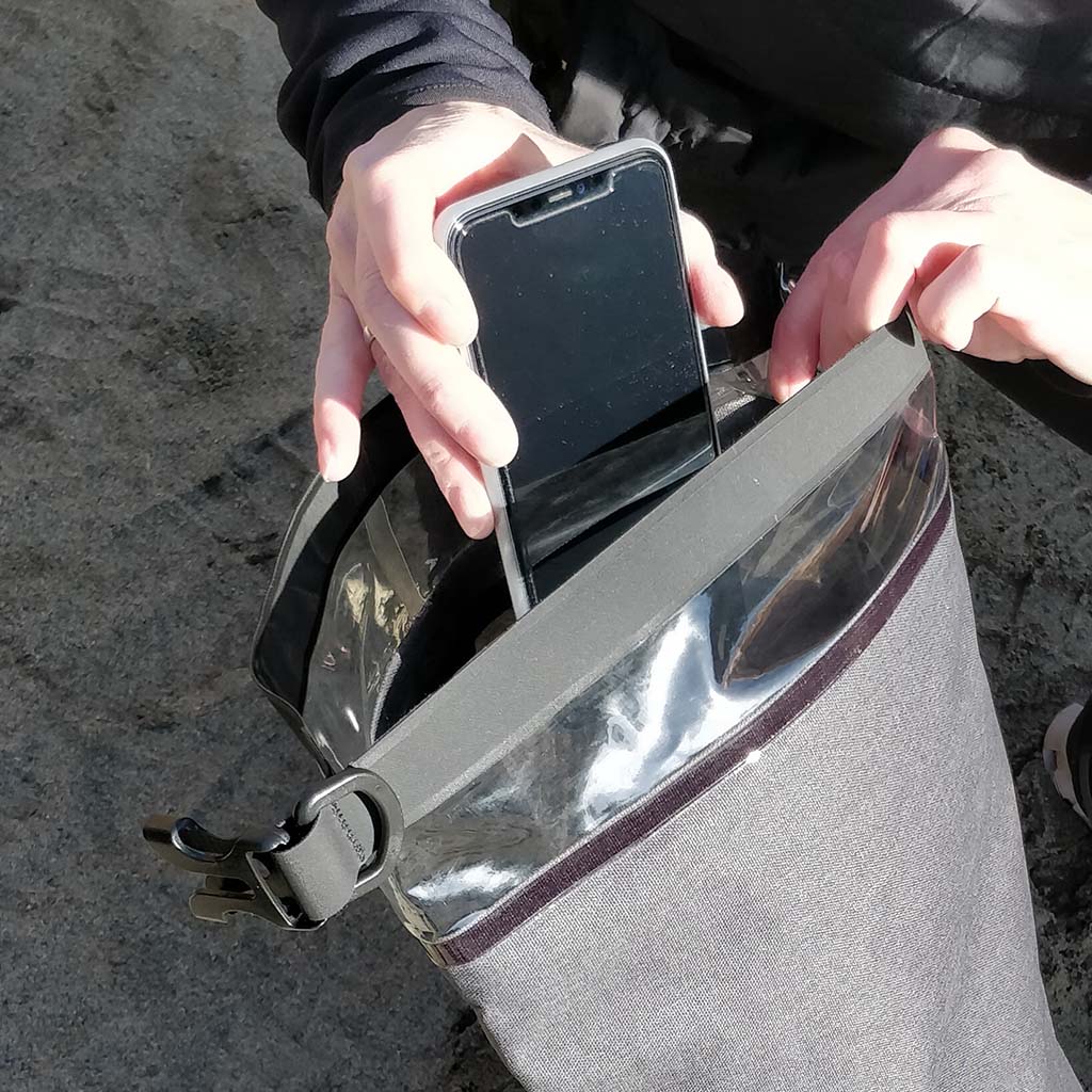 slipping phone into the 10L GoDark dry bag