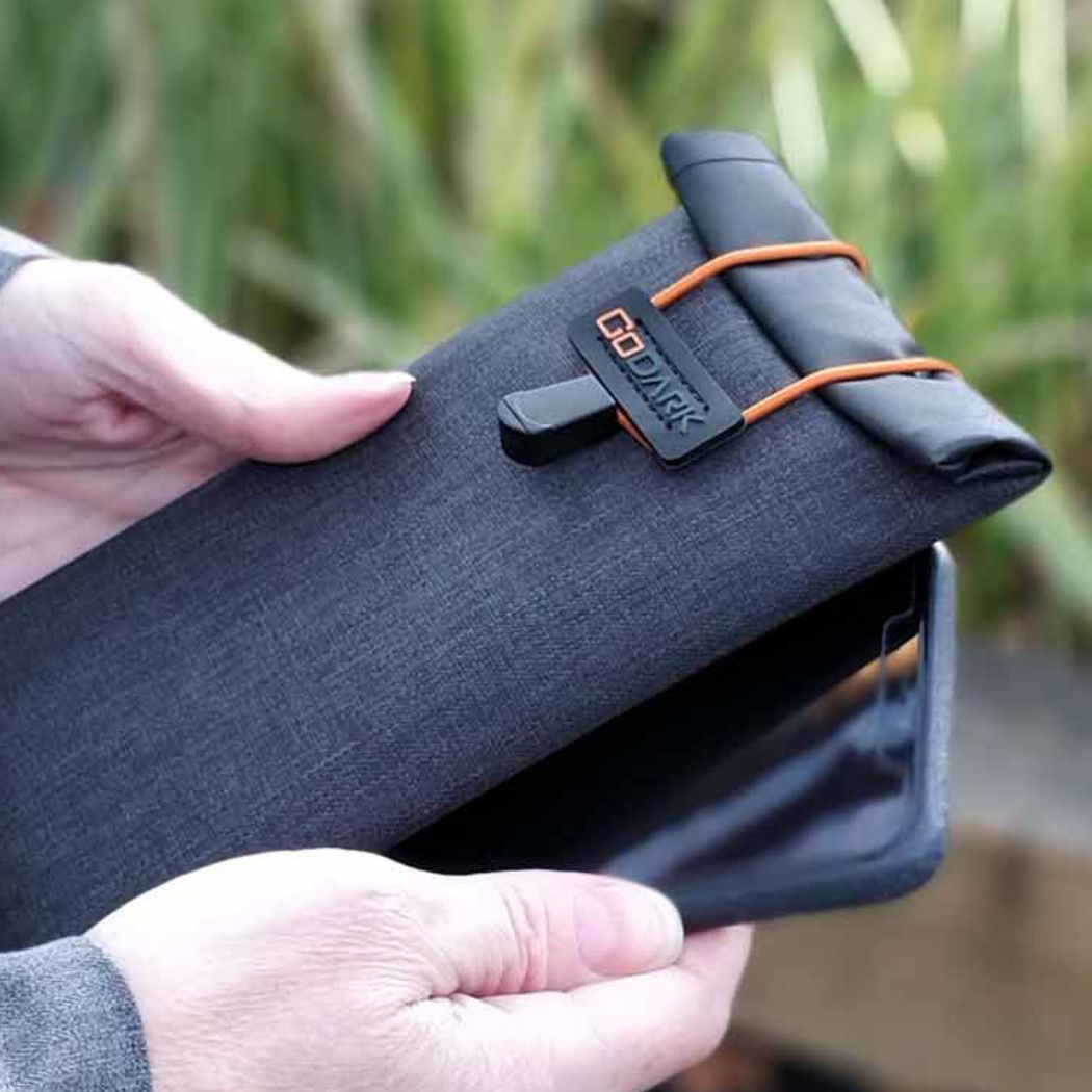 Person holding GoDark Farday Phone Bag and cellphone
