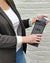 woman with GoDark Phone Bag and putting a phone in it
