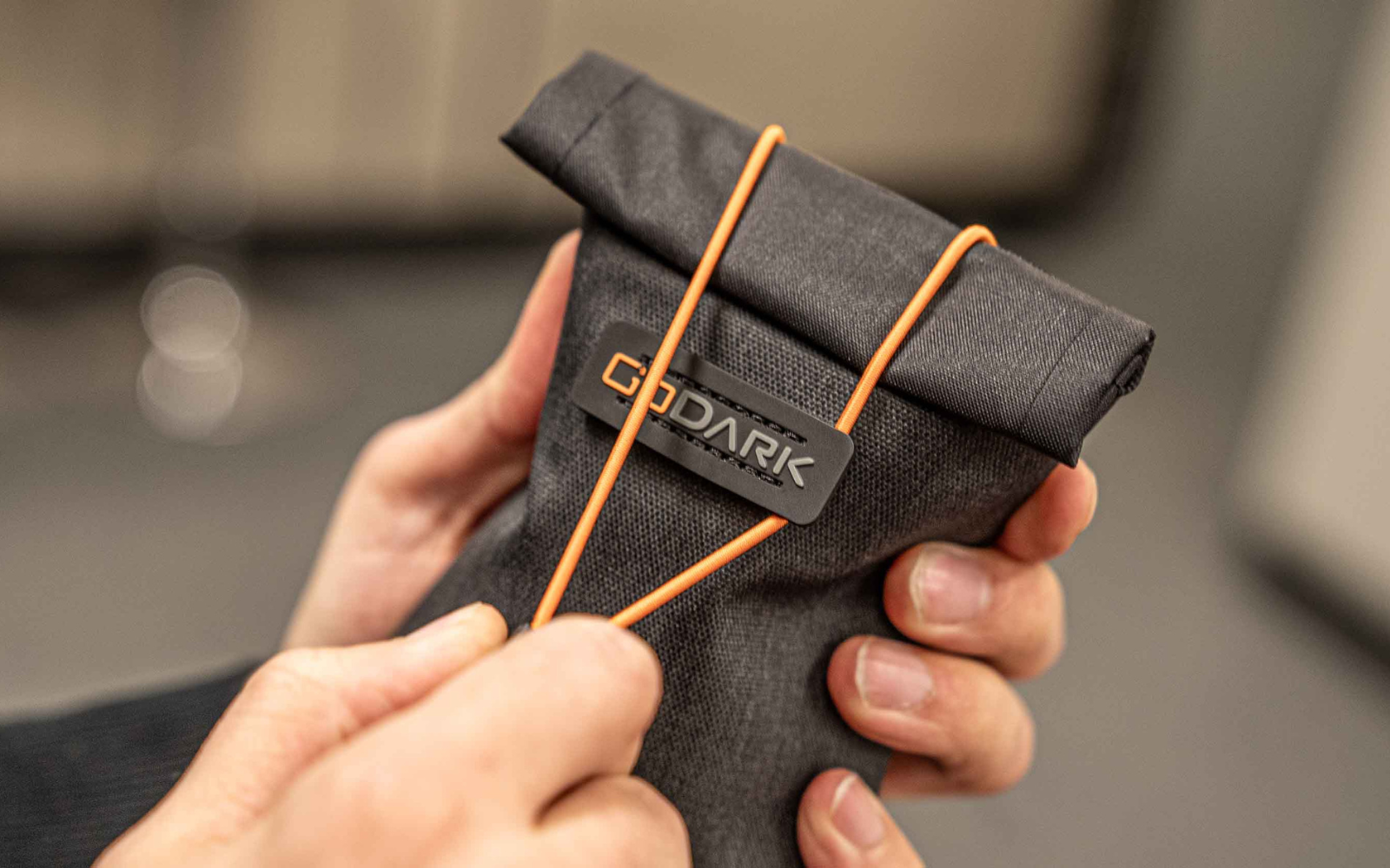 Person holding GoDark phone bag