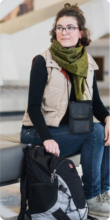 Girl at airport with neck wallet